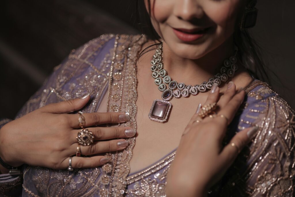 Close-up of a smiling woman in intricate bridal attire and jewelry.